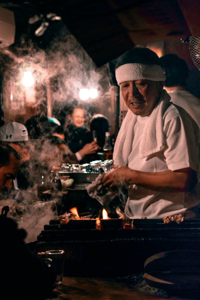 A line cook working the grill