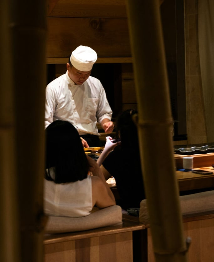 Restaurant staff in white preparing a bill