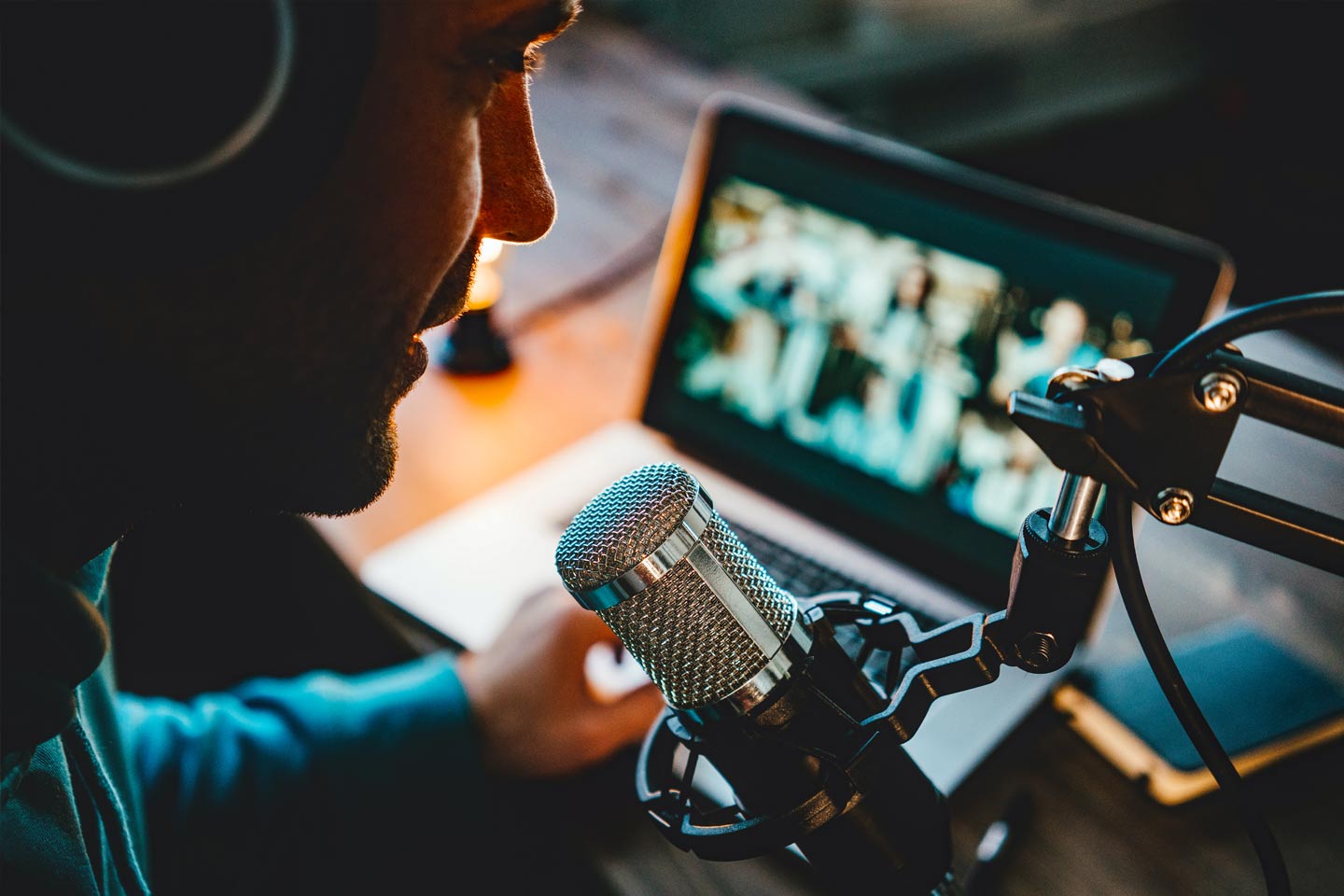 a man doing a podcast talking in a microphone in a studio
